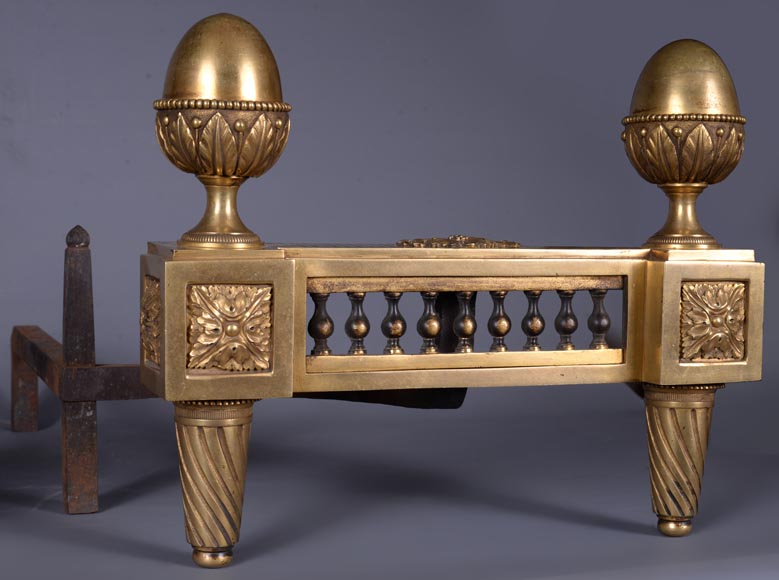 BOUHON: Paire de chenets de style Louis XVI en bronze doré aux pommes de pin stylisées-2