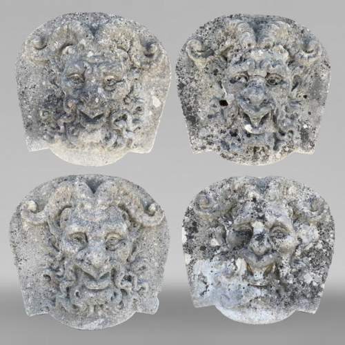 Ensemble de quatre médaillons en pierre sculptée représentant des visages de satyres